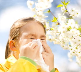 Image showing Little girl is blowing her nose