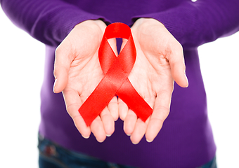 Image showing Woman is holding the red awareness ribbon