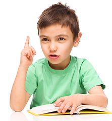 Image showing Little boy is reading a book