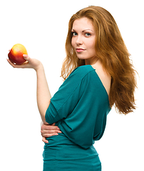 Image showing Young happy girl with apple