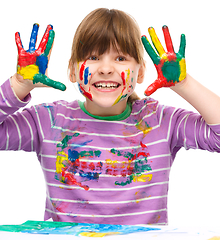 Image showing Portrait of a cute girl playing with paints