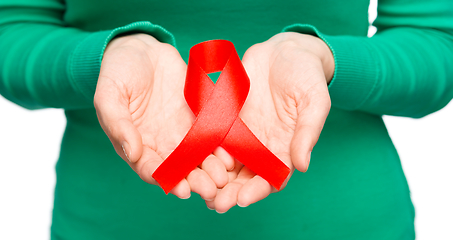 Image showing Woman is holding the red awareness ribbon