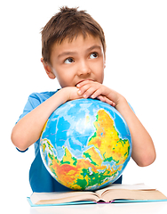 Image showing Little boy is holding globe