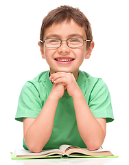 Image showing Little boy is reading a book