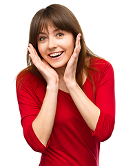 Image showing Woman is holding her face in astonishment