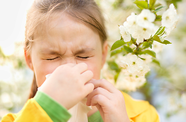 Image showing Little girl is blowing her nose