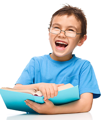 Image showing Little boy is reading a book