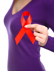 Image showing Woman is holding the red awareness ribbon