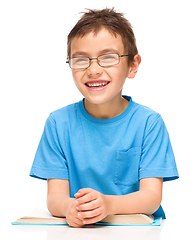 Image showing Little boy is reading a book