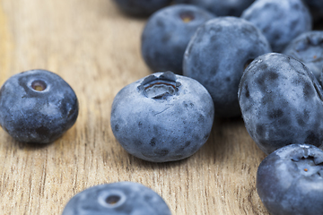 Image showing some blueberries on a wooden table