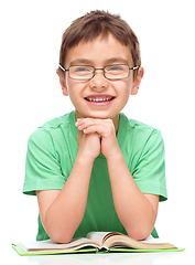 Image showing Little boy is reading a book