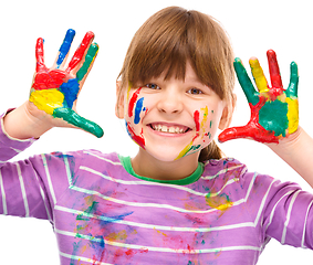 Image showing Portrait of a cute girl playing with paints