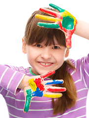 Image showing Portrait of a cute girl playing with paints