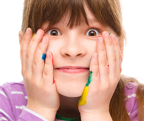 Image showing Little girl is holding her face in astonishment