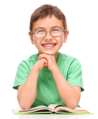 Image showing Little boy is reading a book