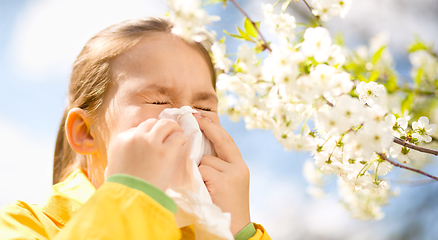 Image showing Little girl is blowing her nose