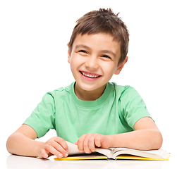 Image showing Little boy is reading a book