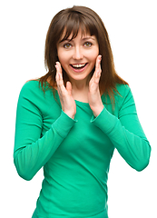 Image showing Woman is holding her face in astonishment