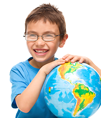 Image showing Little boy is holding globe