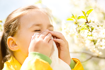 Image showing Little girl is blowing her nose