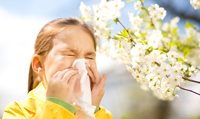 Image showing Little girl is blowing her nose