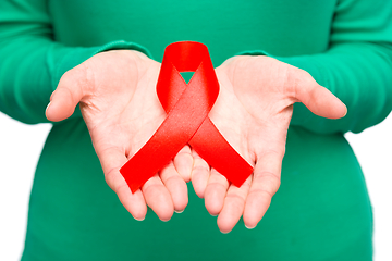 Image showing Woman is holding the red awareness ribbon