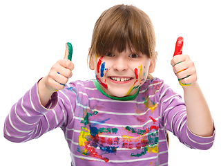 Image showing Portrait of a cute girl playing with paints