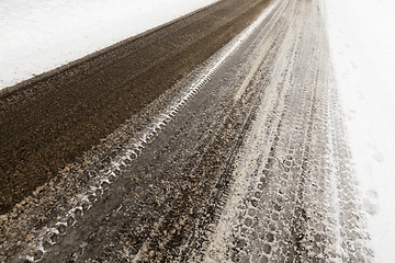 Image showing melted snow on asphalt road close up