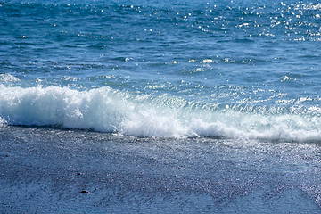 Image showing ocean water on black sand