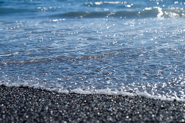 Image showing ocean water on black sand