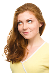 Image showing Young happy woman is looking up and smile