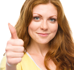 Image showing Woman is showing thumb up gesture