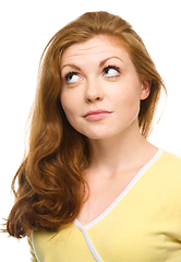 Image showing Young happy woman is looking up and smile