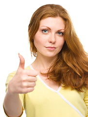 Image showing Woman is showing thumb up gesture