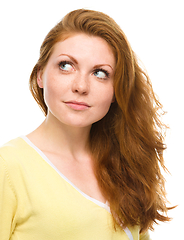 Image showing Young happy woman is looking up and smile