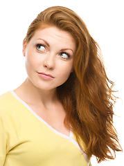 Image showing Young happy woman is looking up and smile