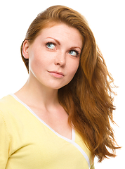 Image showing Young happy woman is looking up and smile