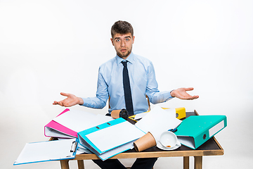 Image showing The young man has a complete mess in the workplace, he cannot organize his space