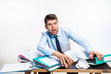 Image showing The young man has a complete mess in the workplace, he cannot organize his space