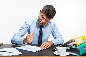 Image showing The ink in the pen ended abruptly and the man is forced to write in pencil