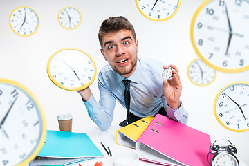 Image showing Young man can\'t wait to go home from the nasty office