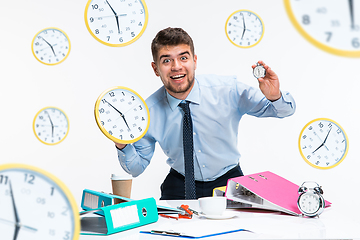 Image showing Young man can\'t wait to go home from the nasty office