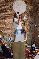 Image showing Woman recording music, broadcasting and singing at home