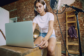 Image showing Woman recording music, broadcasting and singing at home