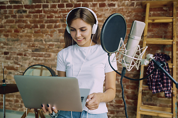 Image showing Woman recording music, broadcasting and singing at home