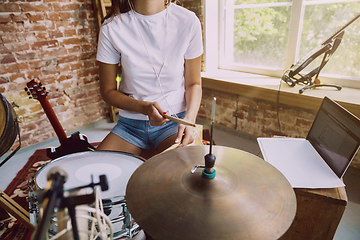 Image showing Woman recording music, playing drums and singing at home