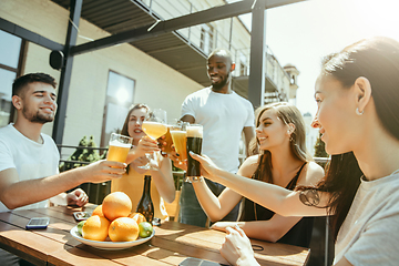 Image showing Young group of friends drinking beer and celebrating together