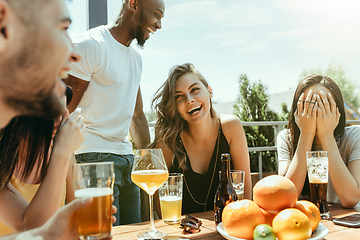 Image showing Young group of friends drinking beer and celebrating together