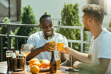 Image showing Young men drinking beer and celebrating together