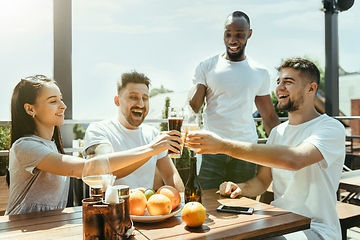 Image showing Young group of friends drinking beer and celebrating together